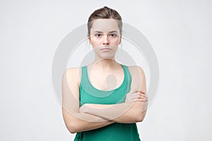 Aggravated sad woman standing crossed hands expressing her dissatisfaction and disconent