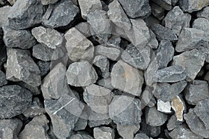 Aggregate of very large coarse gray stones, crushed at a stone pit, gravel pattern