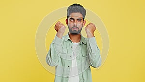 Aggressive angry Indian man trying to fight at camera, shaking fist, boxing, punishment, threaten