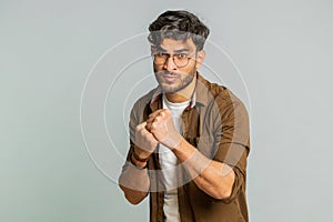 Aggressive angry Indian man trying to fight at camera, shaking fist, boxing, punishment, threaten