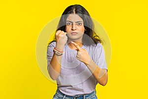 Aggressive angry Indian woman trying to fight at camera, shaking fist, boxing, punishment, threaten