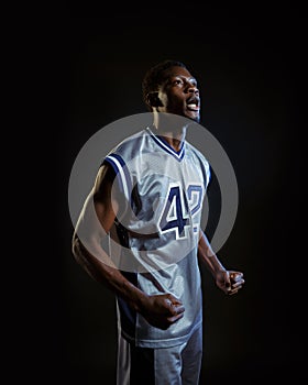 Aggressive basketball player poses in studio