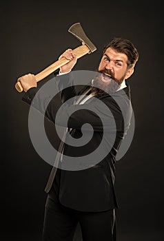 Aggressive bearded man in suit threaten with axe dark background, rage