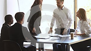 Aggressive blond and brunette businesswomen conflict during business meeting