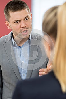 Aggressive Businessman Bullying Female Colleague In Office