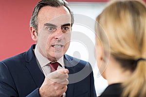 Aggressive Businessman Shouting At Female Colleague