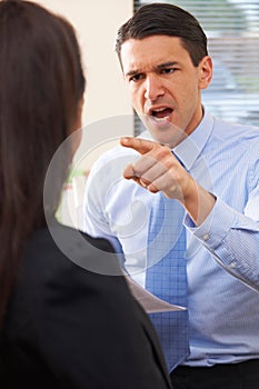 Aggressive Businessman Shouting At Female Colleague