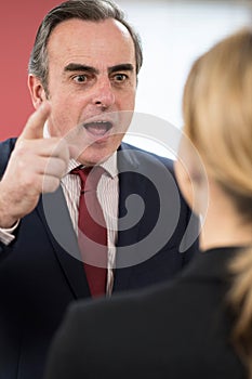 Aggressive Businessman Shouting At Female Colleague