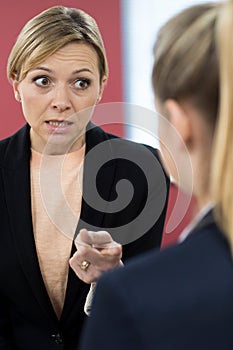 Aggressive Businesswoman Shouting At Female Colleague