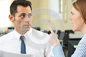 Aggressive Businesswoman Shouting At Male Colleague