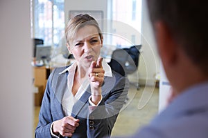 Aggressive Businesswoman Shouting At Male Colleague