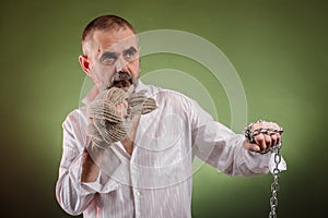 Aggressive elderly man with chain in his hand