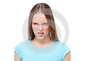 Aggressive face of a young girl isolated on white.