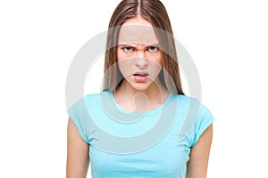 Aggressive face of a young girl isolated on white.