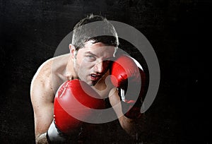 Aggressive fighter man boxing angry with red fighting gloves posing in boxer stance
