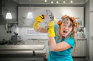 Aggressive housewife woman washing dishes in kitchen