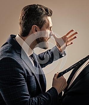 Aggressive lawyer in suit make threaten gesture pulling man necktie grey background, threatening