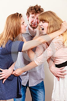 Aggressive mad women fighting over man.