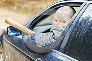 Aggressive man with a baseball bat in car