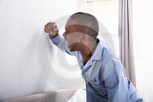 Aggressive Man Hitting Wall