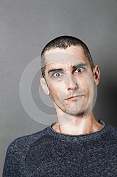 Aggressive man looking skeptical, scary and surprised, expressing suspicion