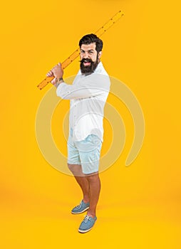 aggressive man with measuring ruler in studio. man with measuring ruler on background.