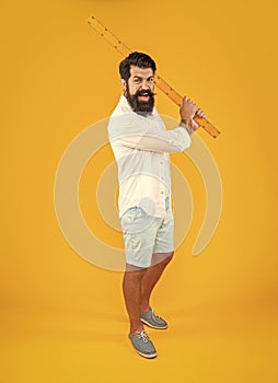 aggressive man with measuring ruler in studio. man with measuring ruler on background.