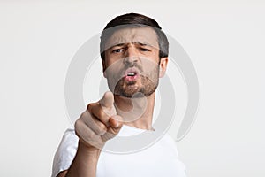 Aggressive Man Pointing Finger At Camera Blaming You, White Background