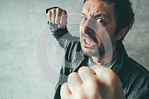 Aggressive man punching with fist, victim`s pov