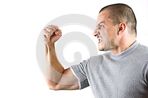 Aggressive man showing his fist isolated on white