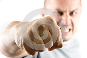 Aggressive man showing his fist isolated on white photo