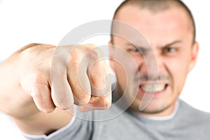 Aggressive man showing his fist isolated on white