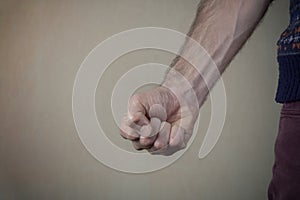 Aggressive man threatens with clenched fist. Violence and aggression concept