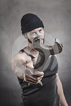 Aggressive man using a wrench as a weapon