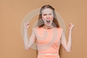 Aggressive screaming woman looking at camera.