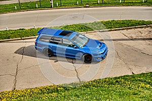 Aggressive sport car in blue against the background of nature