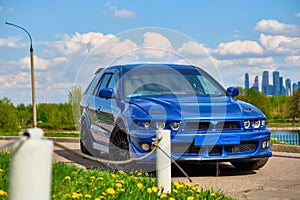Aggressive sport car in blue against the background of nature