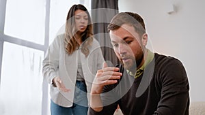 Aggressive woman abuser screaming at scared husband at home