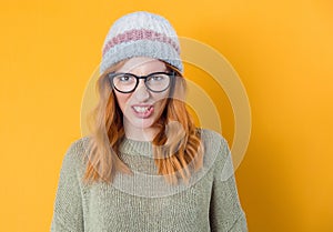 Aggressive young woman screaming, isolated on yellow background. Frustrated pretty woman