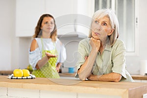 Aggrieved elderly woman having quarrel with her daughter