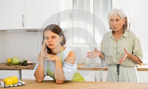 Aggrieved woman having quarrel with her elderly mother