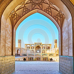 The Agha Bozorg mosque through the arch, Kashan, Iran