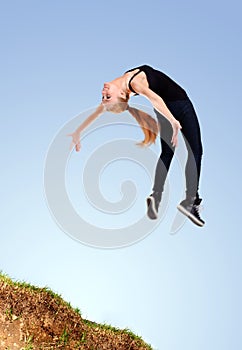 Agile funky young woman jumping