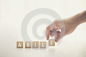 Agile and Scrum in Software Development concepts, Hand pick wooden cube and place with text to fill the word AGILE. Brochure