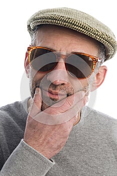 Aging artist thinking sunglasse scottish tweed hat