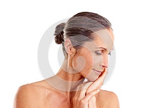 Aging beautifully and with grace. Studio shot of a beautiful mature woman posing against a white background.