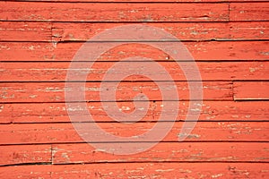 Aging boards on the side of an old red barn