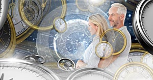 Aging couple in surreal time montage of clocks