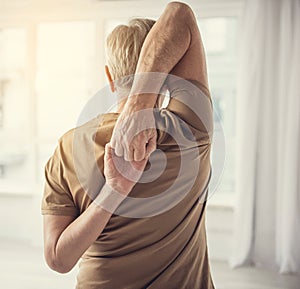 Aging man performing stretching exercise