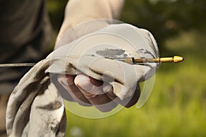 Older man alone on route checking unfunctional engine in late summer light